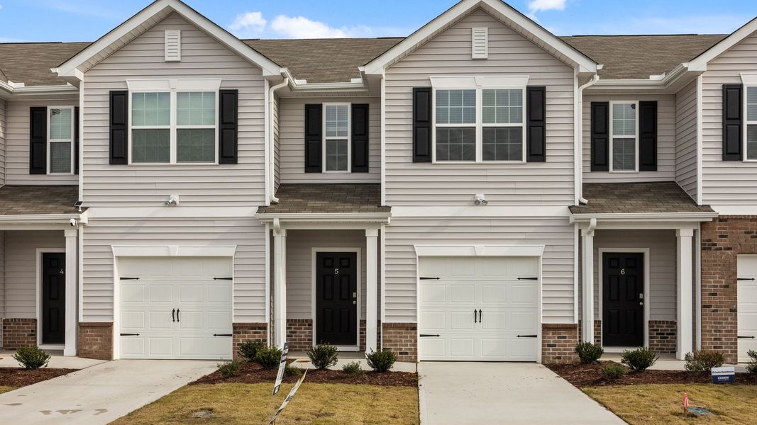 Front exterior of a new home in The Townes at Ridgewood Farms, Winterville, NC, highlighting curb appeal (Image 2). Front exterior of a new home in The Townes at Ridgewood Farms, Winterville, NC, highlighting curb appeal (Image 2).