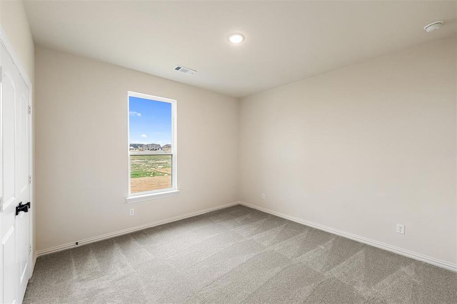 Spare room featuring light colored carpet and recessed lighting