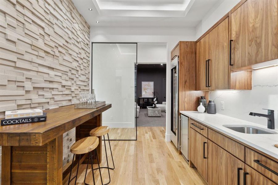 Wet-Bar and wine tasting room is between the living room and media room. Also adjacent to the kitchen.