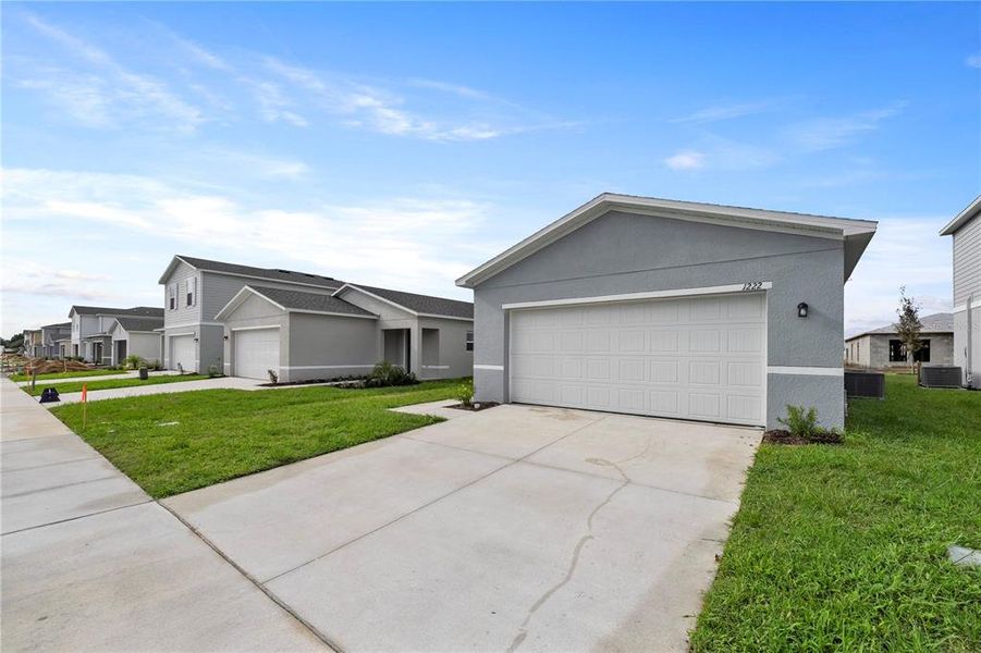 Front exterior of a new home in Eagle Hammock, Eagle Lake, FL, highlighting curb appeal (Image 26). Front exterior of a new home in Eagle Hammock, Eagle Lake, FL, highlighting curb appeal (Image 26).