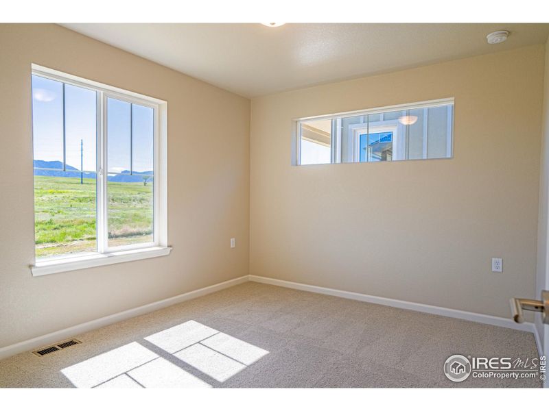 Bedroom 2 with Transom window for light and wall space fro headboard