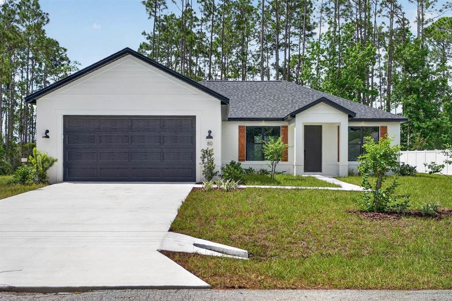 Front exterior of a new home in , Palm Coast, FL, highlighting curb appeal (Image 1). Front exterior of a new home in , Palm Coast, FL, highlighting curb appeal (Image 1).