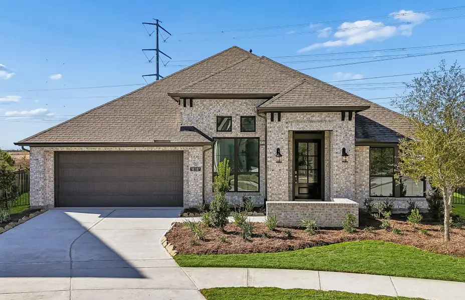 Front exterior of a new home in Bridgeland 60′, Cypress, TX, highlighting curb appeal (Image 1). Front exterior of a new home in Bridgeland 60′, Cypress, TX, highlighting curb appeal (Image 1).