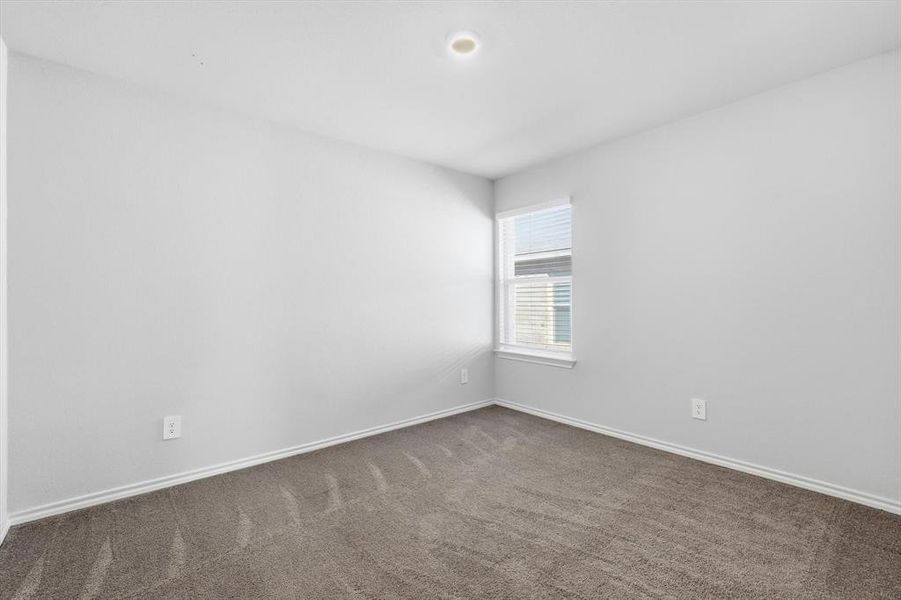 Bedroom 2 with carpet and window Bedroom 2 with carpet and window