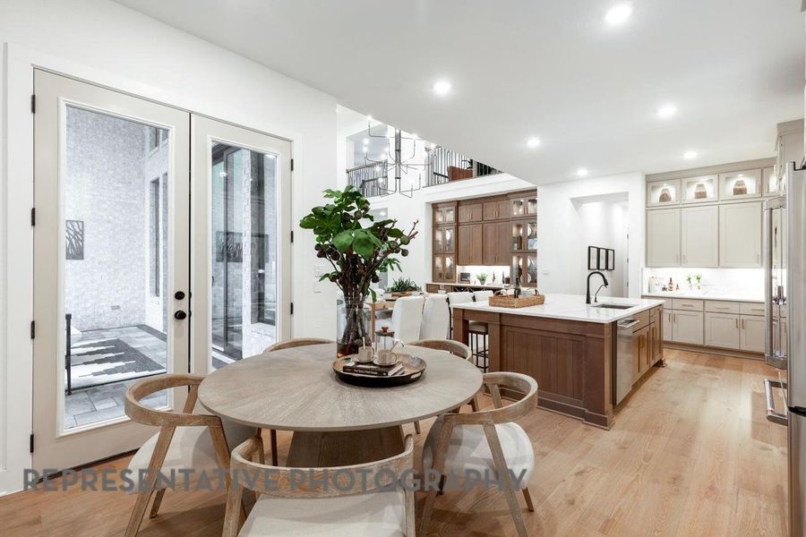 Dining room with light wood-type flooring, french doors, recessed lighting, and a chandelier Dining room with light wood-type flooring, french doors, recessed lighting, and a chandelier