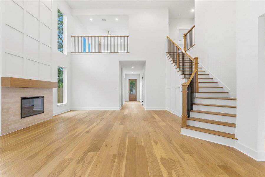 Stunning great room with soaring 21 foot ceilings! An amazing electrical fireplace, plenty of picture windows and sight lines all the way up to your second floor.
