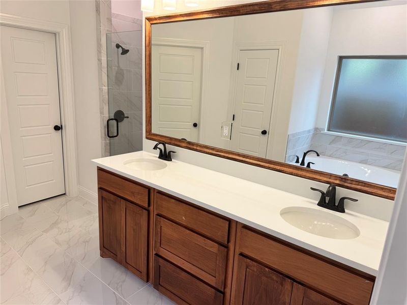 Bathroom featuring plus walk in shower and vanity