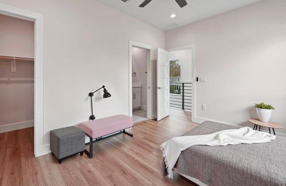Bedroom featuring a walk in closet, light wood-style floors, recessed lighting, ceiling fan, and connected bathroom Bedroom featuring a walk in closet, light wood-style floors, recessed lighting, ceiling fan, and connected bathroom