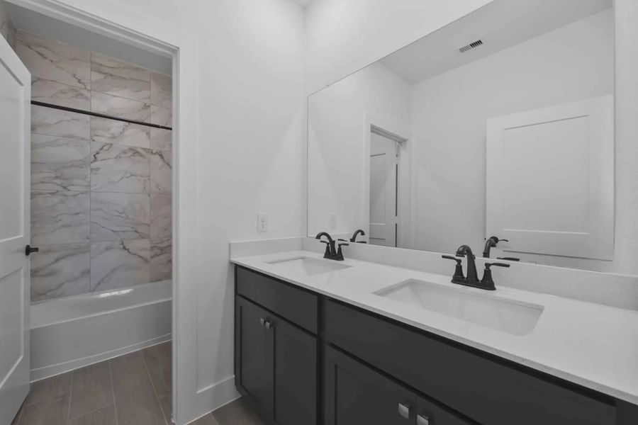 Representative furnished interior of a home built from the Versailles by Chesmar Homes in Meridiana Chateau, Manvel (Image 13).