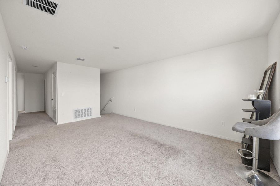 Unfurnished living room with light colored carpet