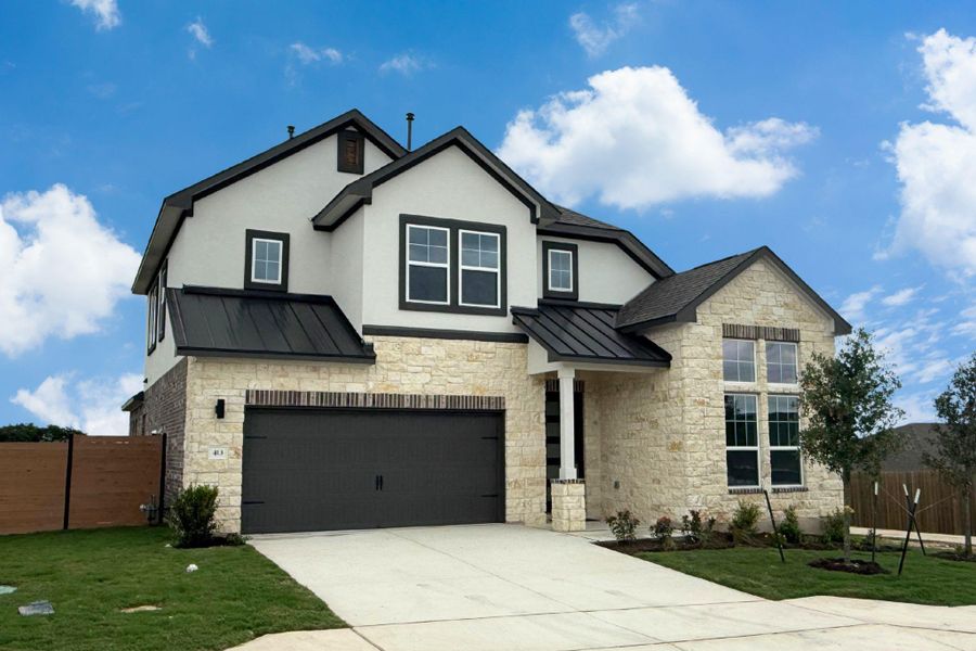 Crafted with elegant stone and stucco, this residence showcases a striking black metal and shingle roof. Crafted with elegant stone and stucco, this residence showcases a striking black metal and shingle roof.
