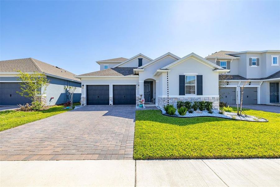 Front exterior of a new home in Hartwood Landing, Clermont, FL, highlighting curb appeal (Image 24).