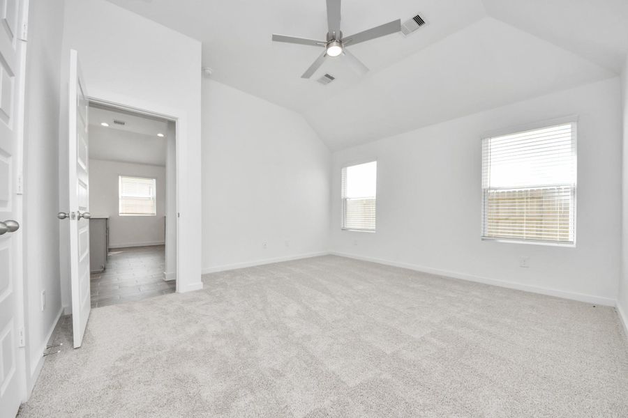 Come and unwind after a long day in this magnificent primary suite! This spacious room features plush carpet, warm paint, high ceilings and large windows with privacy blinds.