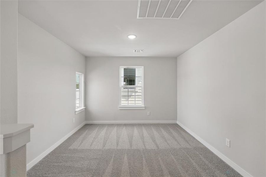 Empty room featuring light colored carpet and recessed lighting