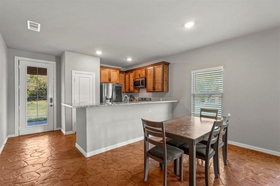 Kitchen with kitchen peninsula, and light stone countertops