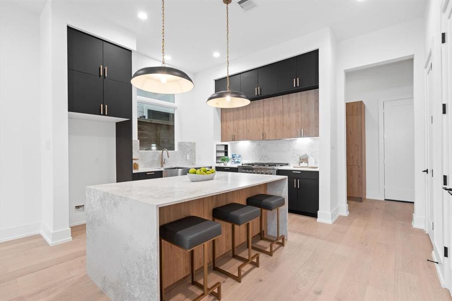 Kitchen island with waterfall quartz countertops.