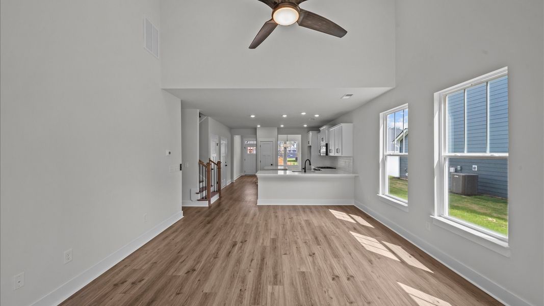 Refined and memorable, this family room features two-story ceilings and top-notch comfort throughout