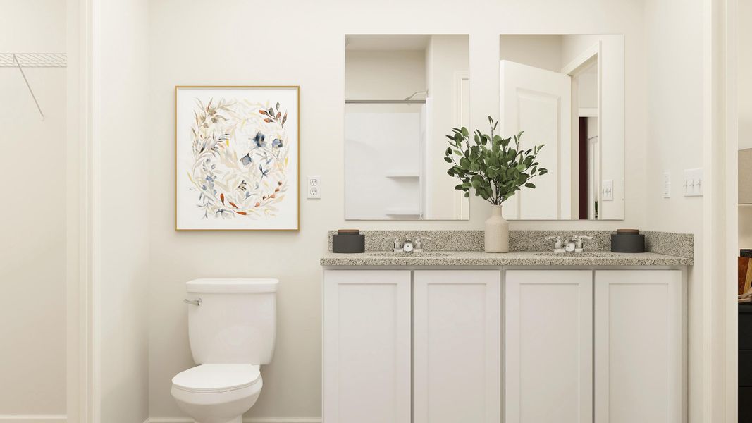 A bathroom with a plant on the counter.