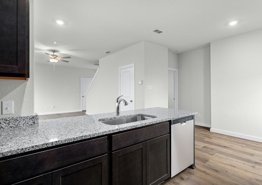 The kitchen looks out at the large living room.