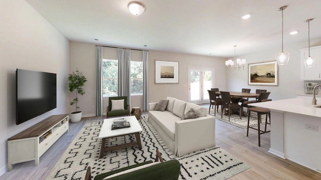Kitchen with white cabinets, quartz countertops, and island seating.