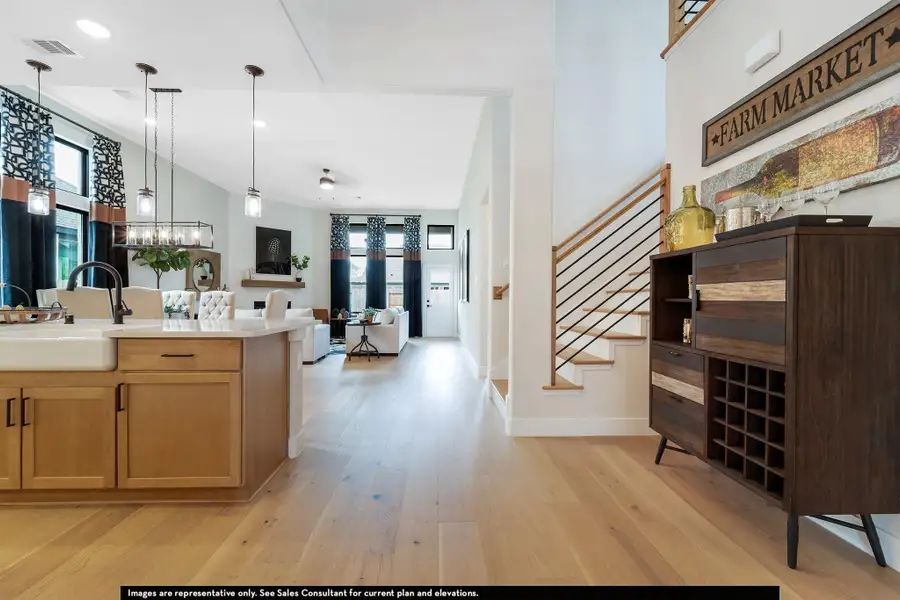 Kitchen featuring pendant lighting, light wood-style floors, open floor plan, recessed lighting, and light stone counters Kitchen featuring pendant lighting, light wood-style floors, open floor plan, recessed lighting, and light stone counters