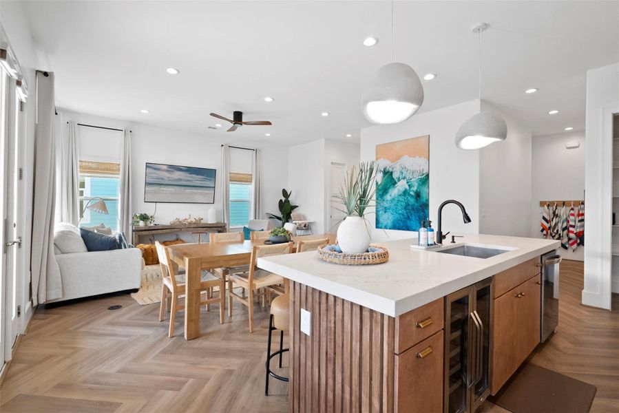 This open-concept space beautifully blends the kitchen and living area, featuring coastal-inspired tones and textures. The light wood cabinetry and sleek island seamlessly flow into the airy living room, creating a relaxed yet refined atmosphere perfect for everyday living or entertaining. This open-concept space beautifully blends the kitchen and living area, featuring coastal-inspired tones and textures. The light wood cabinetry and sleek island seamlessly flow into the airy living room, creating a relaxed yet refined atmosphere perfect for everyday living or entertaining.