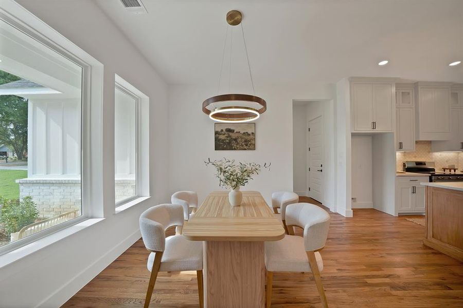 Dining room featuring recessed lighting and light wood-style flooring Dining room featuring recessed lighting and light wood-style flooring