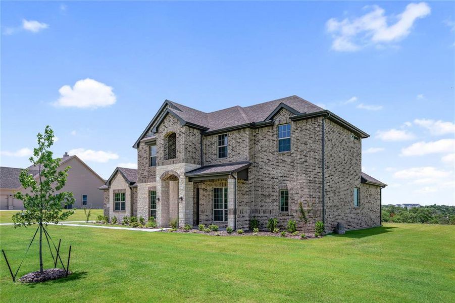 Front exterior of a new home in Eagle Ridge Estates, Weatherford, TX, highlighting curb appeal (Image 2). Front exterior of a new home in Eagle Ridge Estates, Weatherford, TX, highlighting curb appeal (Image 2).