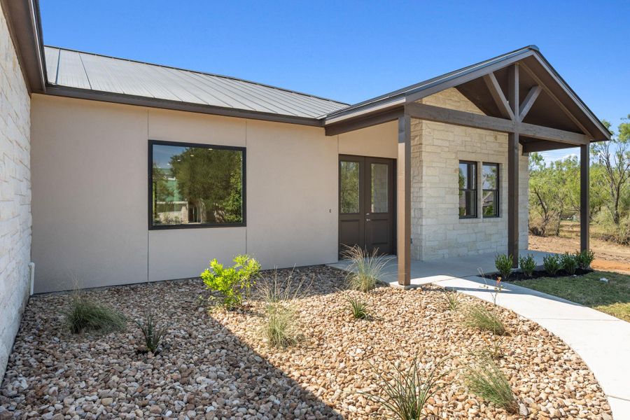 Front exterior of a new home in , Horseshoe Bay, TX, highlighting curb appeal (Image 23). Front exterior of a new home in , Horseshoe Bay, TX, highlighting curb appeal (Image 23).