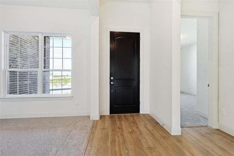 Entrance foyer featuring light wood-style floors and baseboards