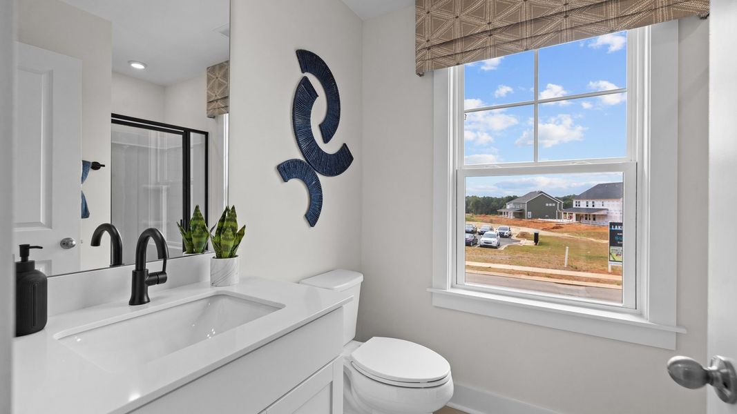 Secondary bathroom with large window, in the Jordan Design by DRB Homes in York, SC
