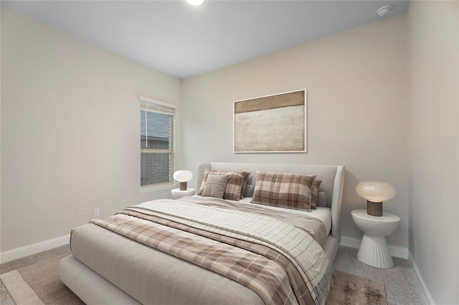 Bedroom with baseboards and light carpet