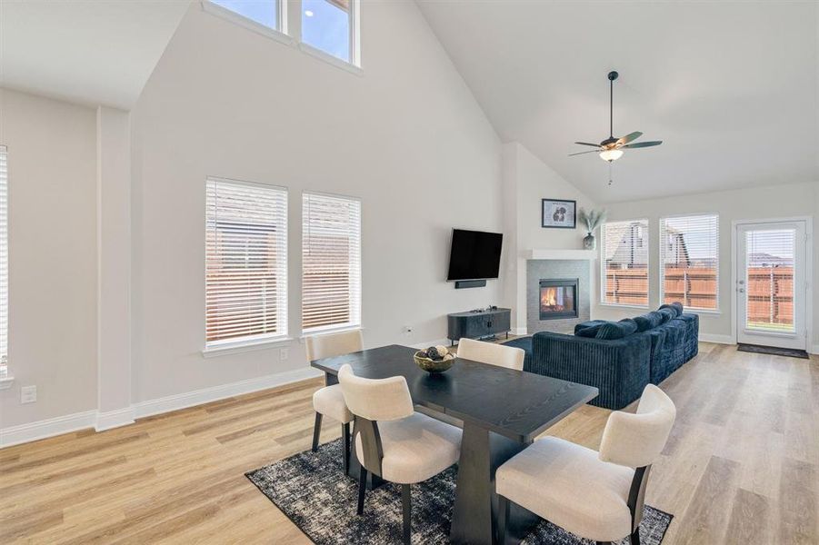 Open-concept living area with vaulted ceilings and wood-finish flooring
