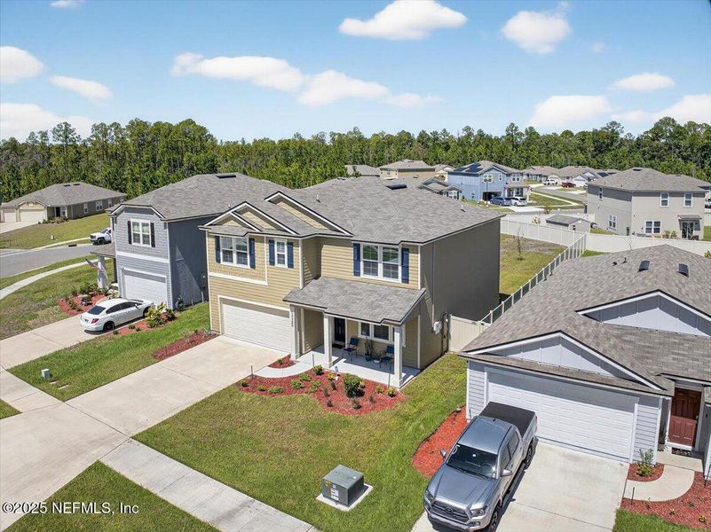 Front exterior of a new home in River Glen Express, Yulee, FL, highlighting curb appeal (Image 21).