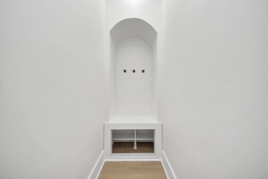 Mudroom hallway featuring several hooks, a bench, and a shoe area—ideal for quick grab-and-go items on your way out the door Mudroom hallway featuring several hooks, a bench, and a shoe area—ideal for quick grab-and-go items on your way out the door