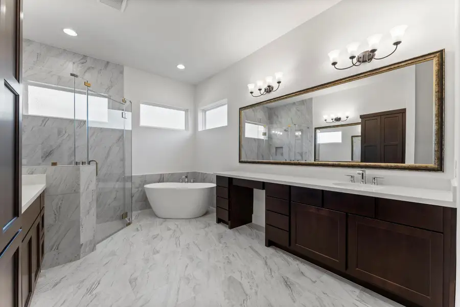 Primary Bath with His and Her vanities along with a soaking tub. Primary Bath with His and Her vanities along with a soaking tub.
