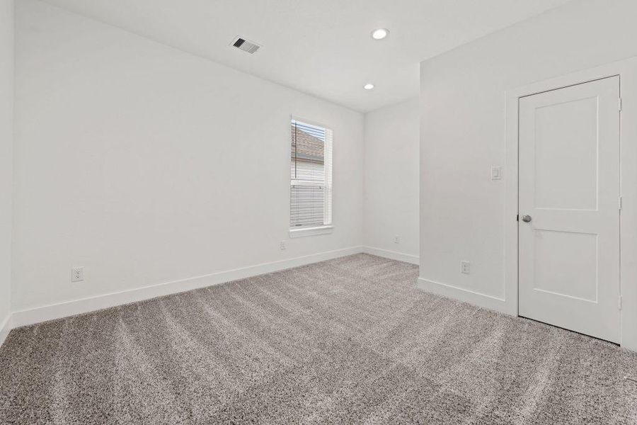 A well-lit room with plush carpeting, offering a clean and versatile space.