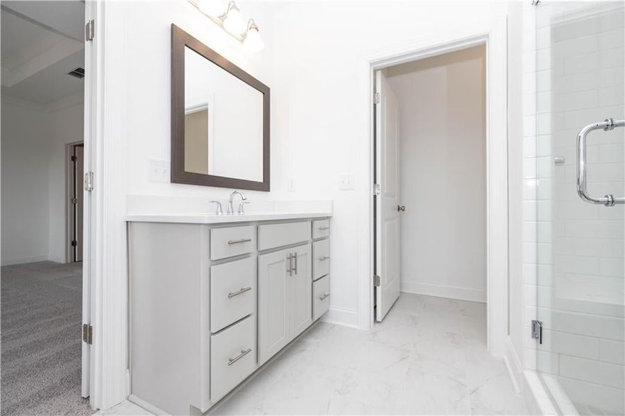 Separate Sinks with a framed mirror - lots of storage for curling iron, flat irons, etc. Pictures represent a previously built home, not the actual home.