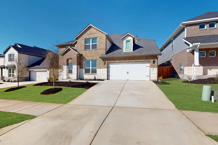 Front exterior of a new home in Edgewood, Leander, TX, highlighting curb appeal (Image 2).
