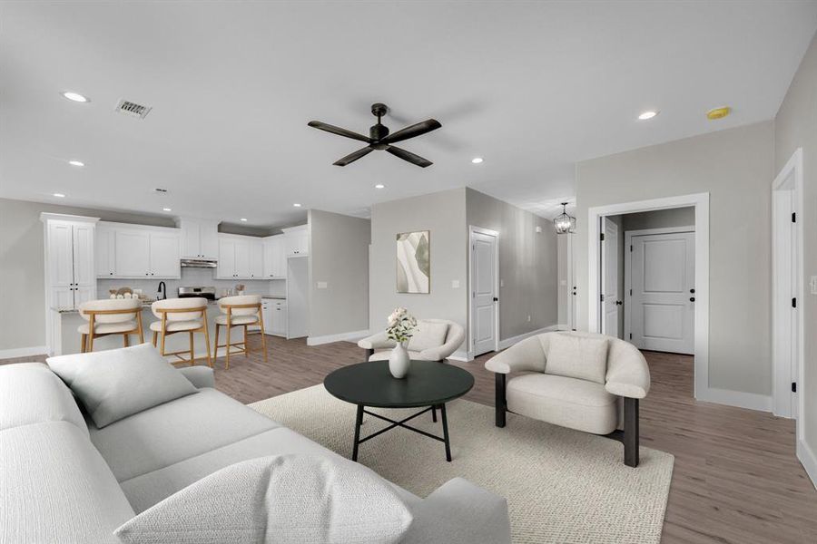 Living room featuring light wood-style flooring, recessed lighting, and ceiling fan