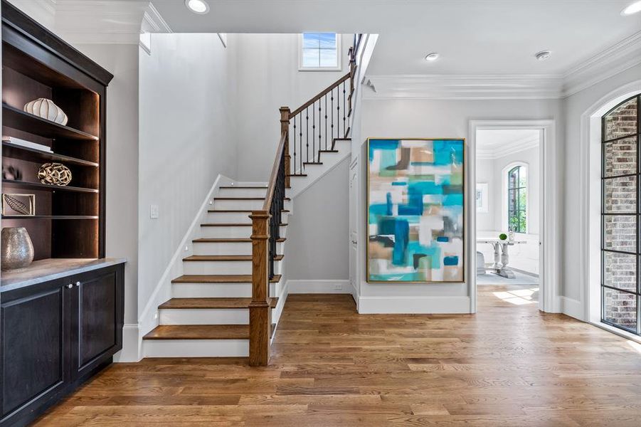 Foyer featuring crown molding and hardwood / wood-style floors