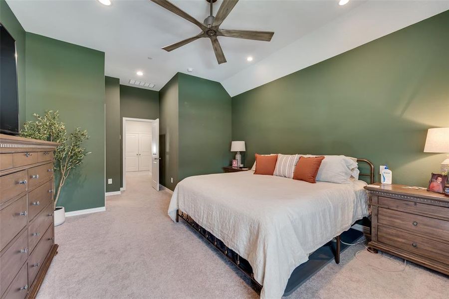 Spacious room featuring vaulted ceilings, recessed lighting, and soft carpet flooring Spacious room featuring vaulted ceilings, recessed lighting, and soft carpet flooring