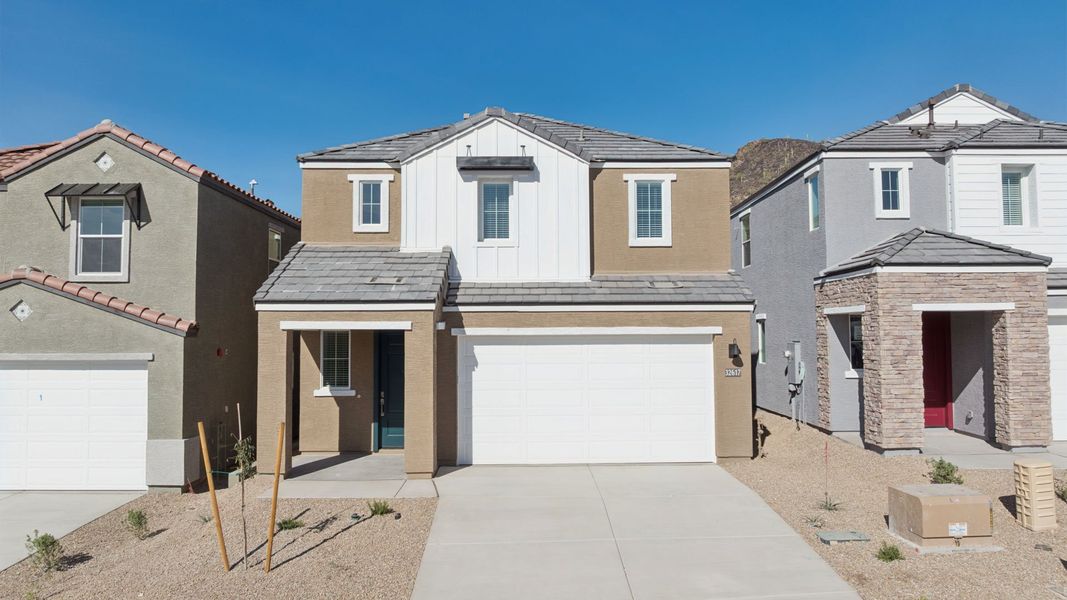 Front exterior of a new home in The Buttes at Mystic, Peoria, AZ, highlighting curb appeal (Image 1). Front exterior of a new home in The Buttes at Mystic, Peoria, AZ, highlighting curb appeal (Image 1).