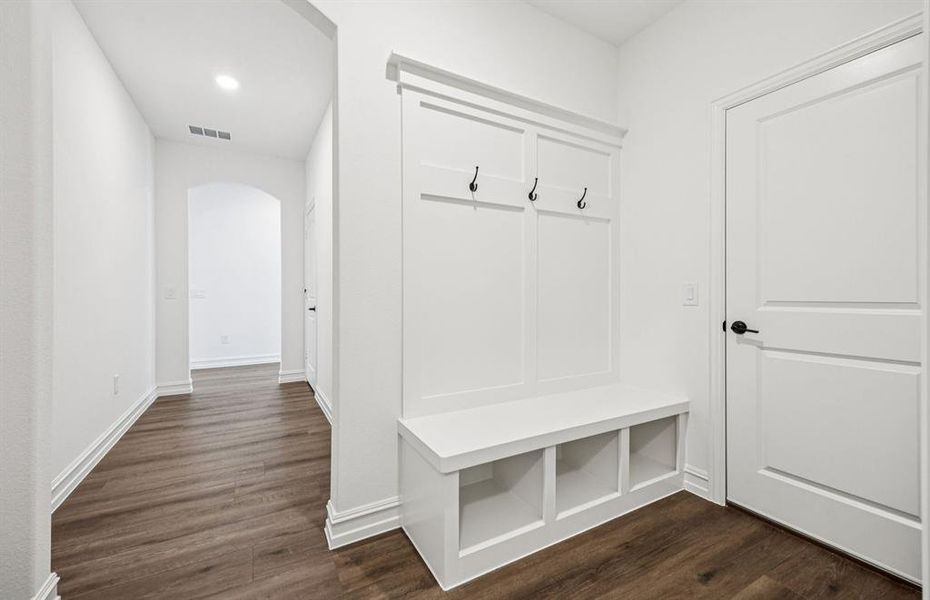 Mud room with built-in bench and hooks for added storage Mud room with built-in bench and hooks for added storage