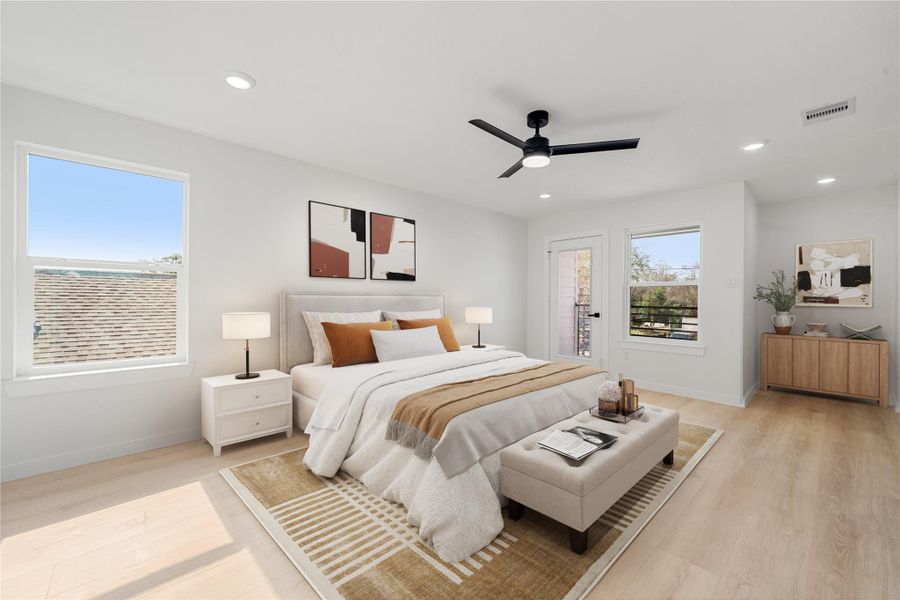 Spacious primary bedroom offering high ceilings, wood-look flooring, recessed lighting, and abundant natural light, with direct access to a private balcony. *Virtually Staged Spacious primary bedroom offering high ceilings, wood-look flooring, recessed lighting, and abundant natural light, with direct access to a private balcony. *Virtually Staged