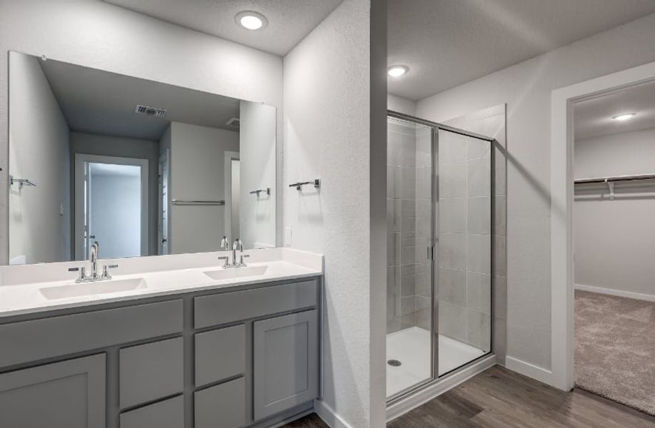 A bathroom with a glass shower. A bathroom with a glass shower.