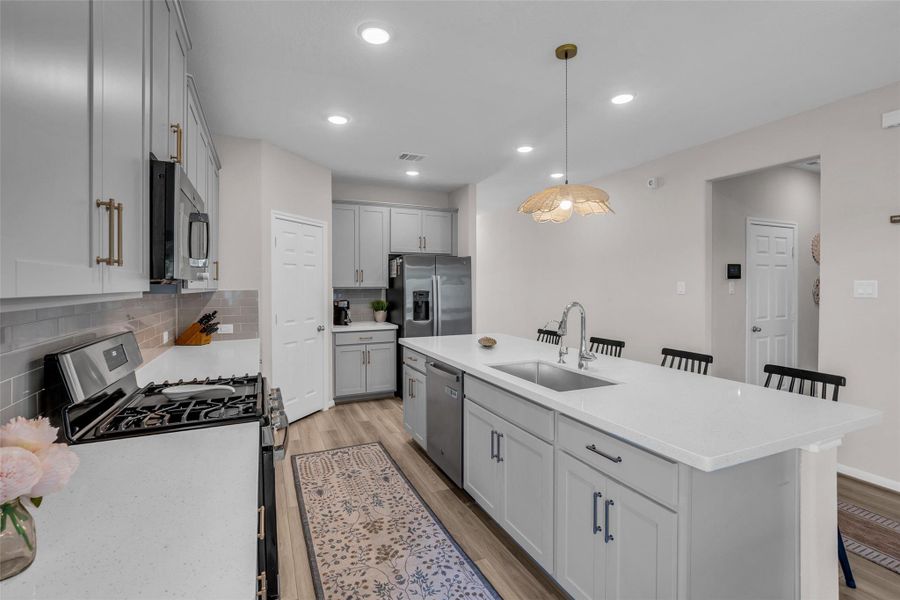 It also offers additional counter space for food preparation, making the kitchen practical for both everyday cooking and entertaining.