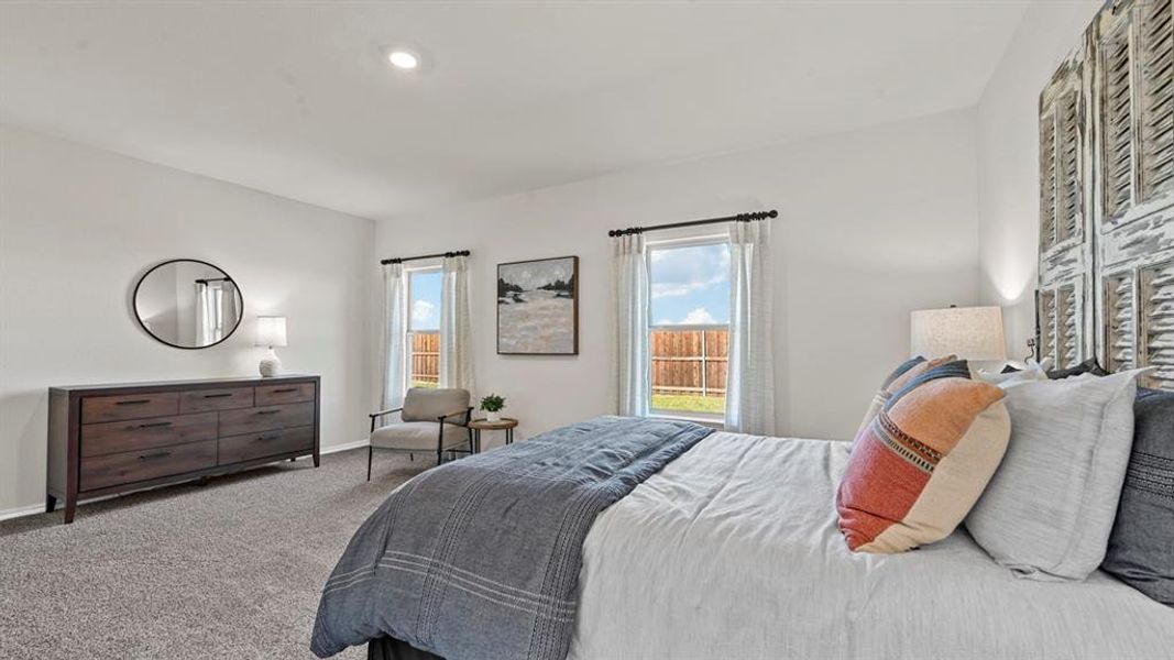 This bright and airy room features light-colored walls and carpeted flooring This bright and airy room features light-colored walls and carpeted flooring