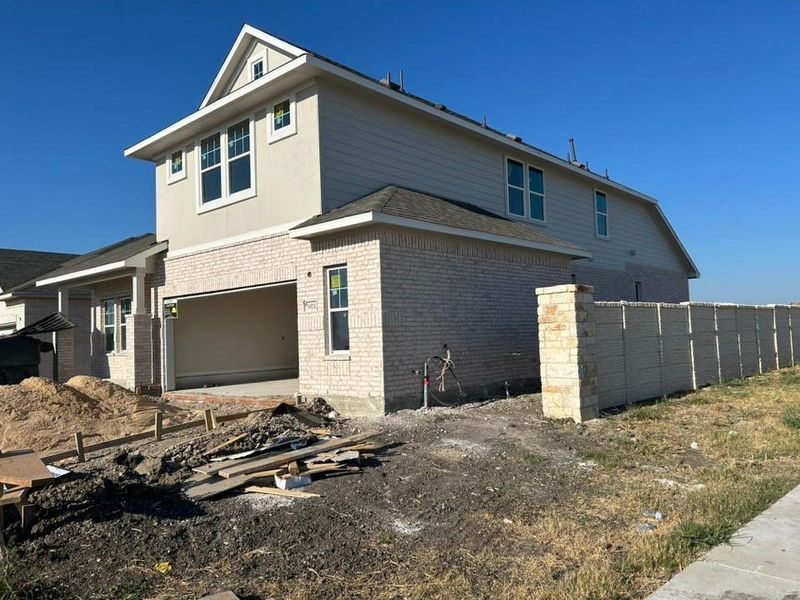 View of side of property featuring brick siding and an attached garage View of side of property featuring brick siding and an attached garage