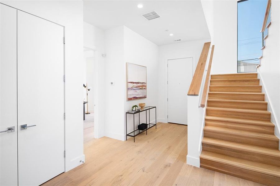 Stairs featuring hardwood / wood-style flooring